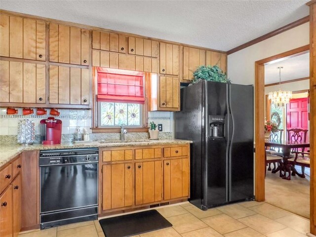 kitchen with crown molding, a chandelier, decorative backsplash, a sink, and black appliances