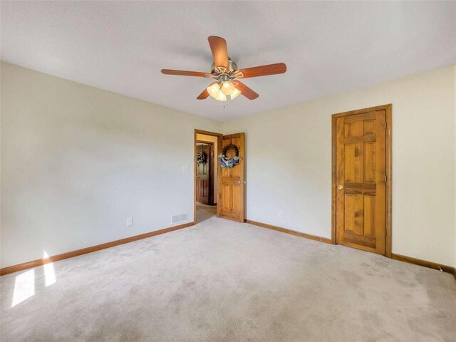 unfurnished room with baseboards, carpet flooring, and ceiling fan