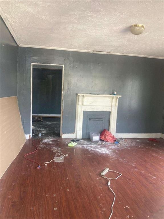 unfurnished living room featuring crown molding and hardwood / wood-style floors