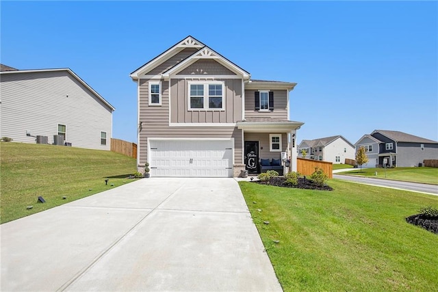 craftsman house with a garage and a front lawn