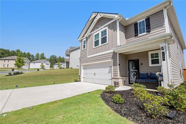 view of front of home with a garage and a front lawn