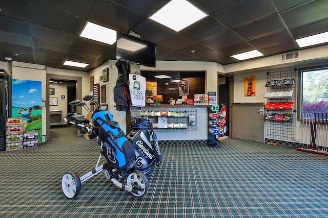 exercise room with a paneled ceiling and carpet floors