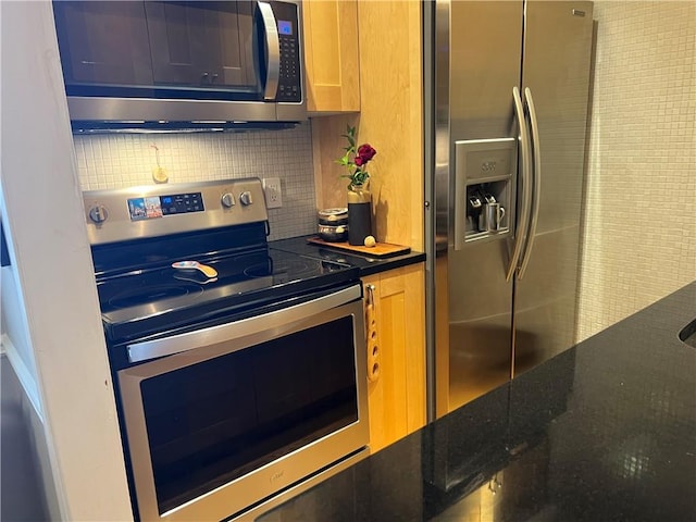 kitchen with backsplash and stainless steel appliances