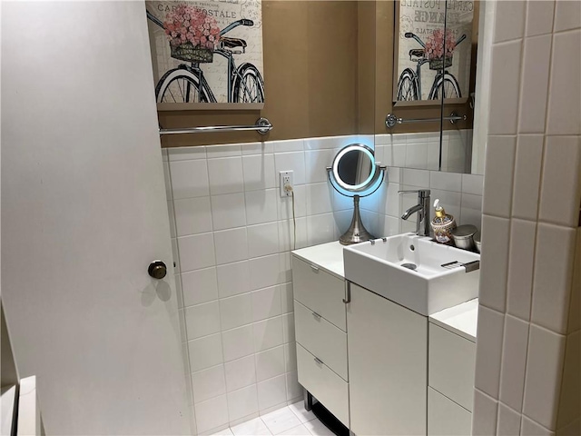 bathroom with tile patterned flooring, vanity, and tile walls