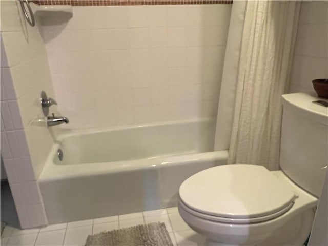 bathroom with toilet, shower / bath combo, and tile patterned floors