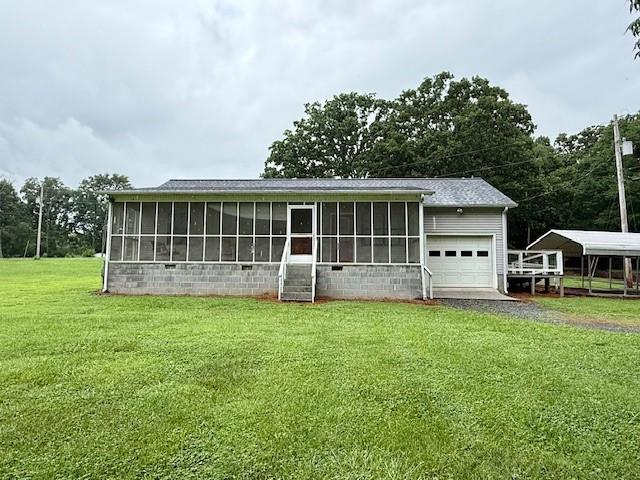 100 Walter Leon Dr, Chatsworth, GA 30705 - view of front facade with a sunroom, a front yard, an attached garage, and driveway