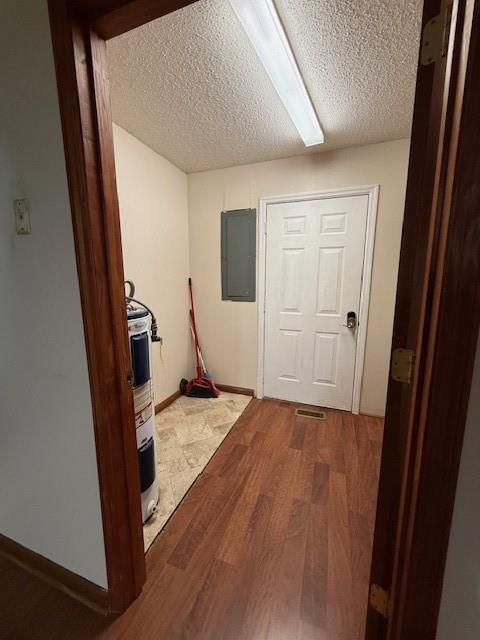 100 Walter Leon Dr, Chatsworth, GA 30705 - corridor featuring electric panel, electric water heater, a textured ceiling, and wood finished floors