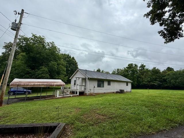 100 Walter Leon Dr, Chatsworth, GA 30705 - back of property with a detached carport and a lawn