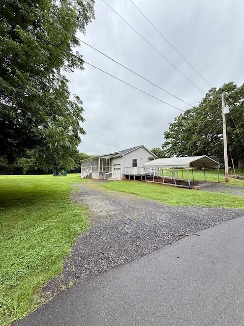 100 Walter Leon Dr, Chatsworth, GA 30705 - view of front of home with a front lawn, a carport, a garage, and driveway