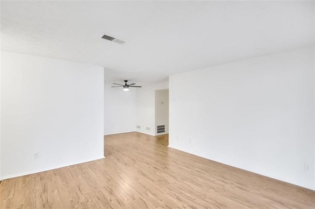 spare room featuring ceiling fan and light hardwood / wood-style floors