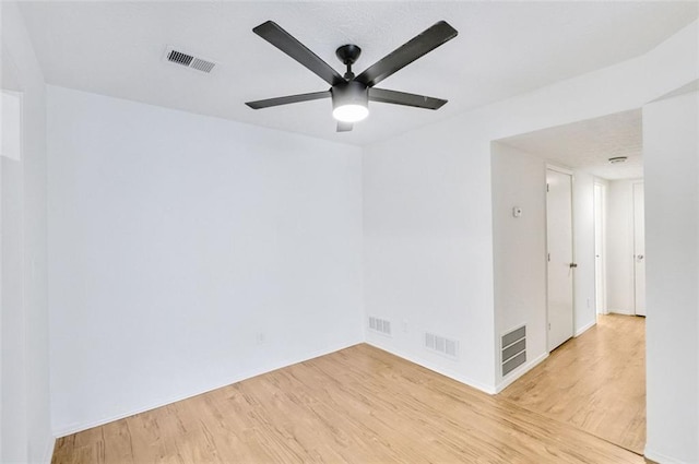 spare room with ceiling fan and light hardwood / wood-style floors