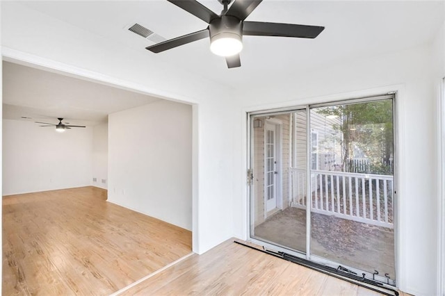 unfurnished room featuring ceiling fan and light wood-type flooring