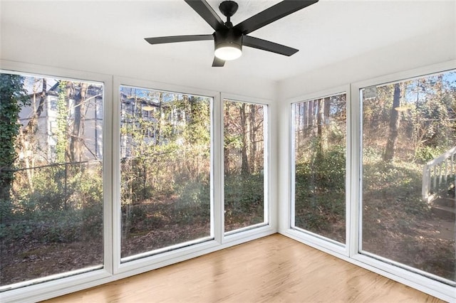 unfurnished sunroom featuring ceiling fan