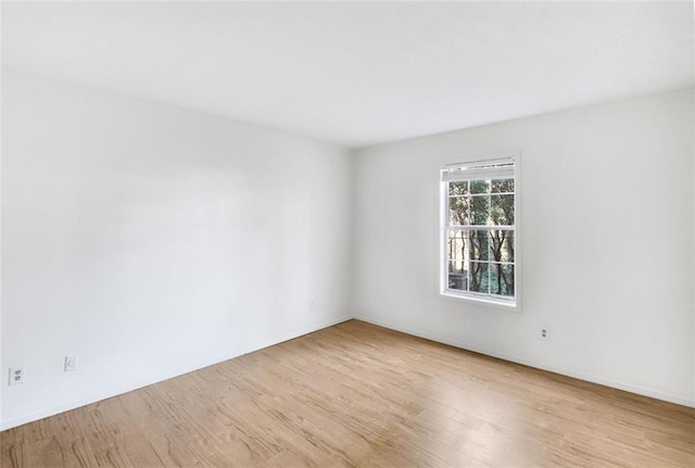 empty room with light hardwood / wood-style flooring