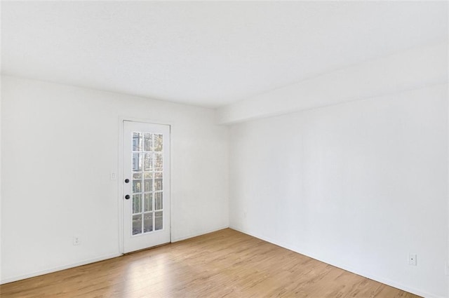 spare room featuring light hardwood / wood-style floors