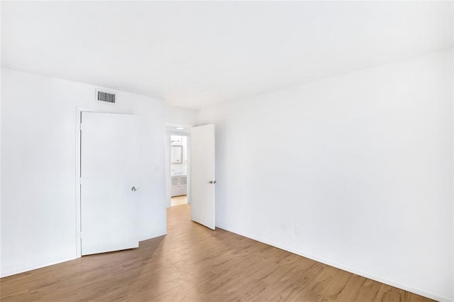 empty room featuring hardwood / wood-style flooring