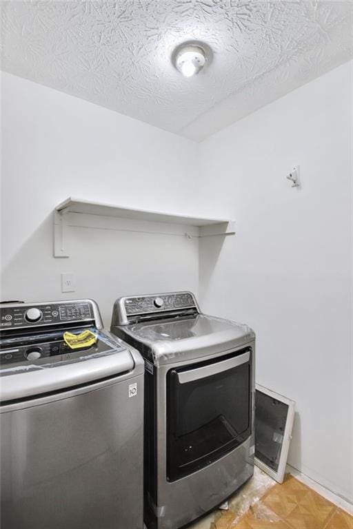 washroom with separate washer and dryer and a textured ceiling