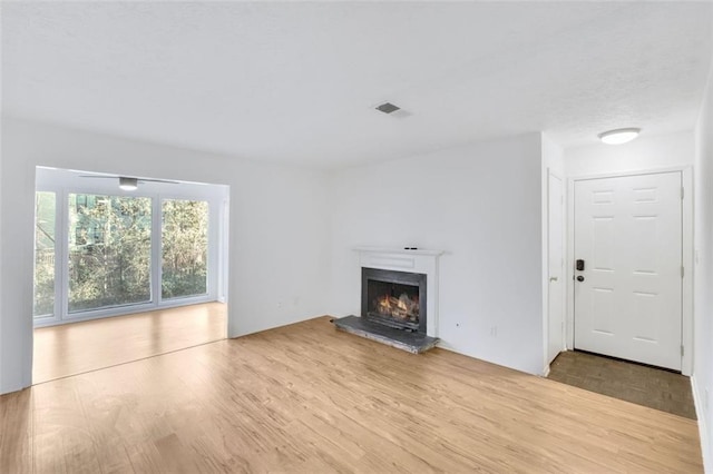 unfurnished living room with light hardwood / wood-style flooring