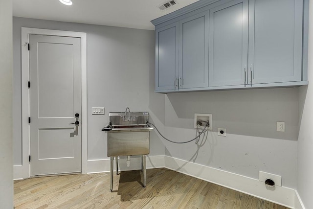 clothes washing area with cabinet space, visible vents, hookup for an electric dryer, light wood-type flooring, and washer hookup