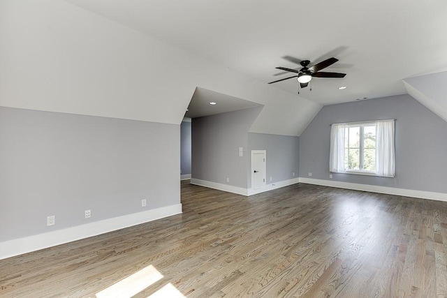 additional living space with ceiling fan, baseboards, vaulted ceiling, and wood finished floors