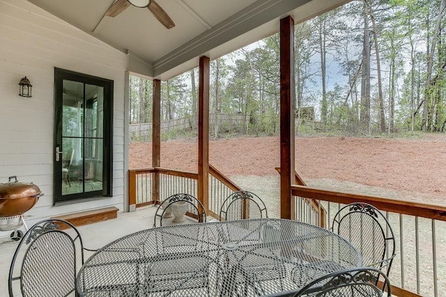 sunroom / solarium featuring a ceiling fan and vaulted ceiling