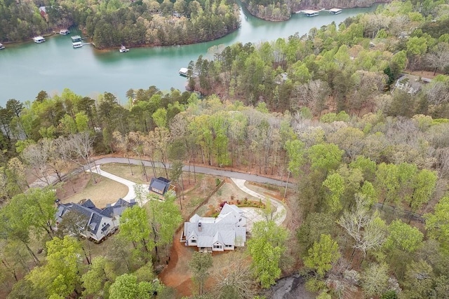 aerial view with a water view and a forest view