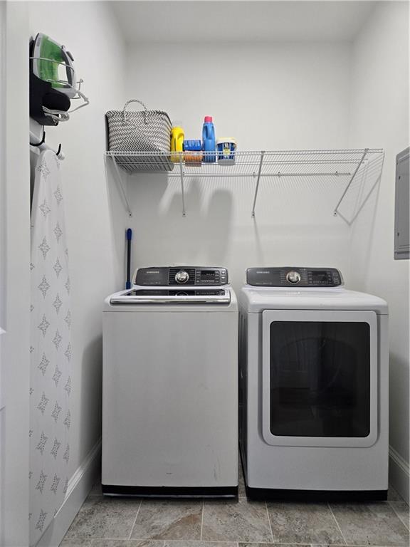 clothes washing area with washing machine and clothes dryer