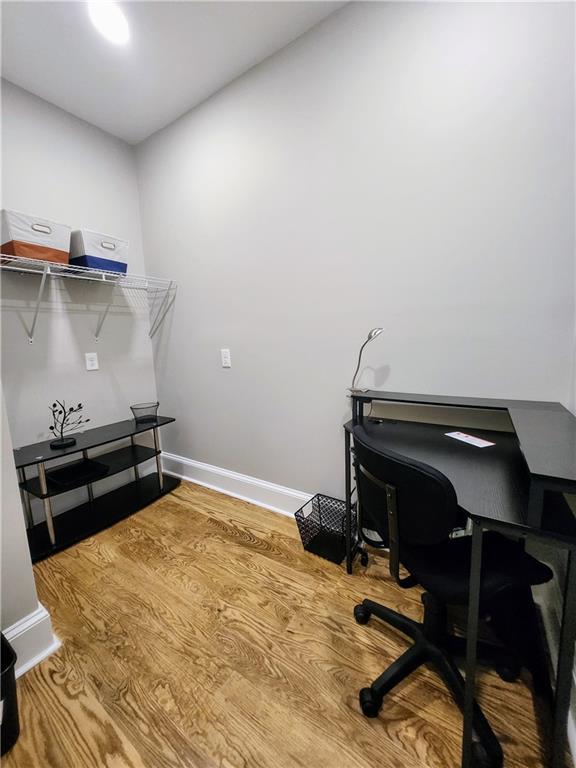 office area featuring baseboards and wood finished floors