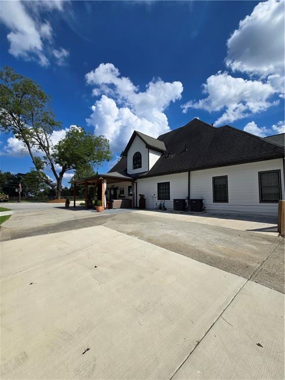 view of property exterior featuring roof with shingles