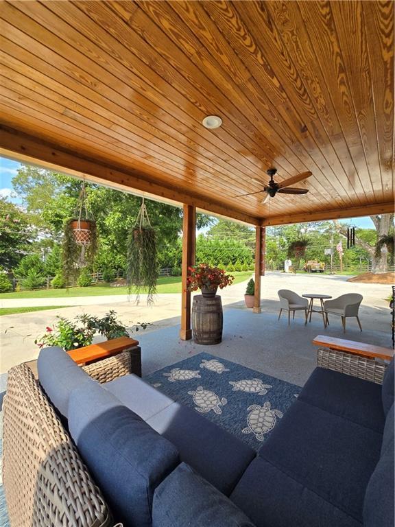 view of patio with a ceiling fan and outdoor dining area