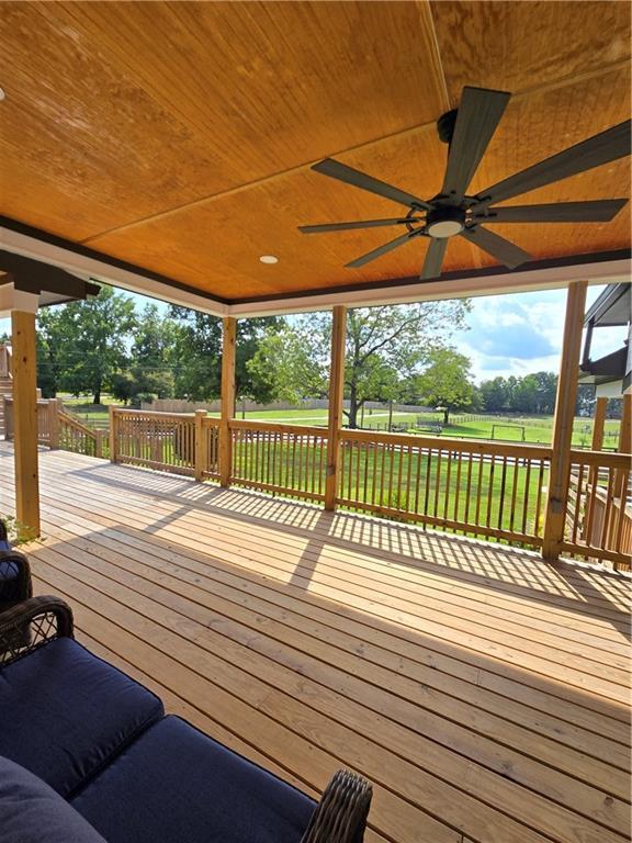 deck featuring a lawn and ceiling fan