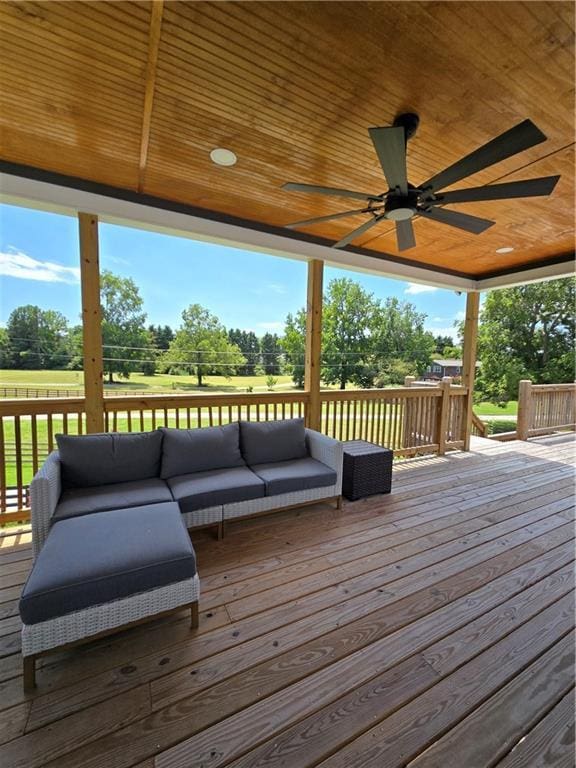 deck featuring ceiling fan and an outdoor living space