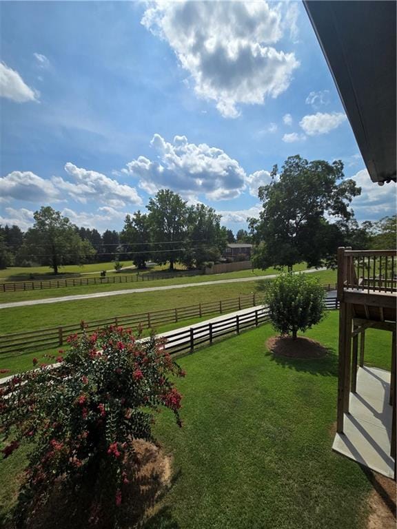 view of yard with a rural view and a deck