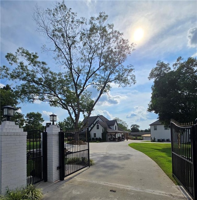 view of gate featuring a yard