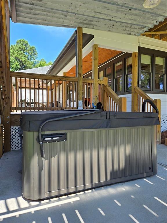 wooden deck featuring a hot tub