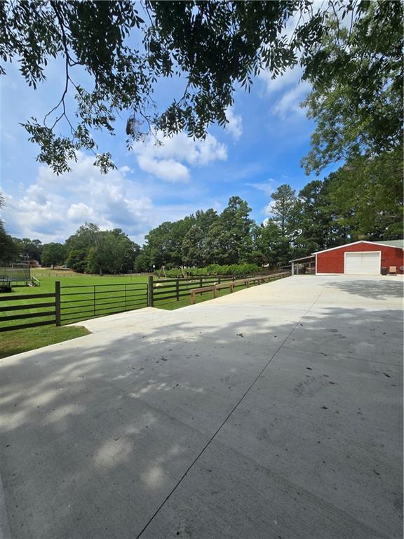 view of yard with a rural view and an outbuilding