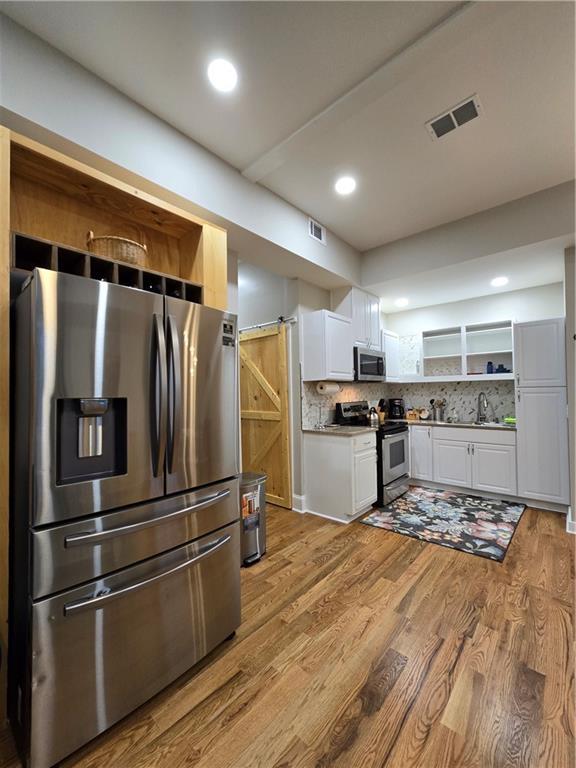 bedroom featuring wood-type flooring, ceiling fan, and lofted ceiling