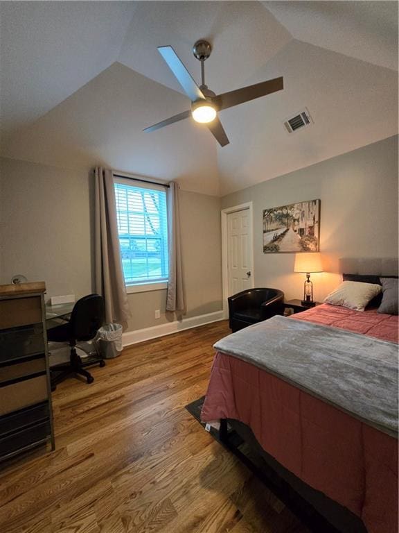 bedroom with lofted ceiling, ceiling fan, wood finished floors, and visible vents