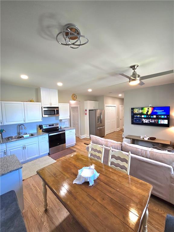 dining area featuring ceiling fan and sink