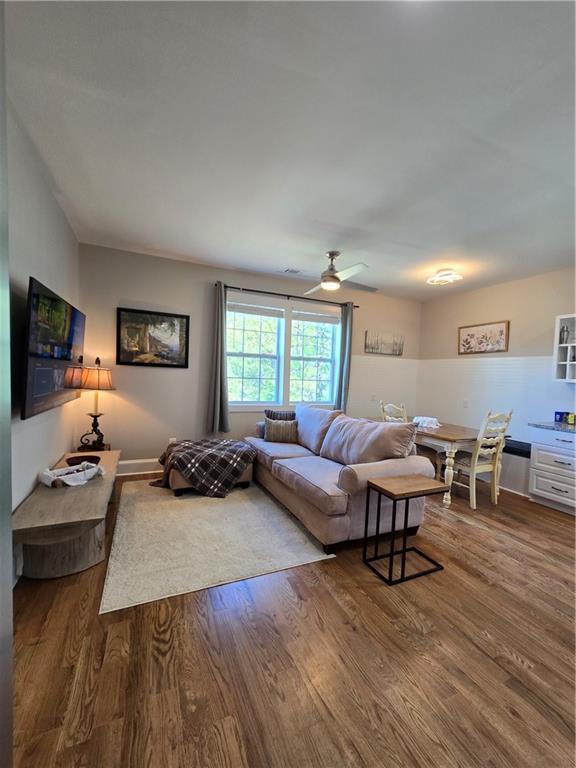 living room with hardwood / wood-style floors and ceiling fan