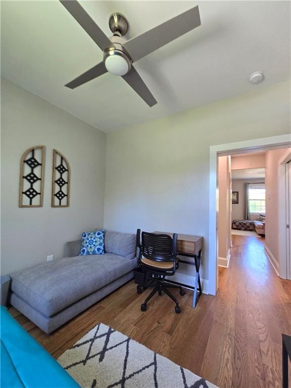 living room featuring ceiling fan and wood-type flooring