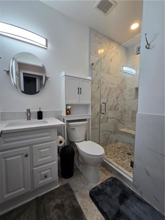 bathroom featuring toilet, recessed lighting, vanity, visible vents, and a shower stall