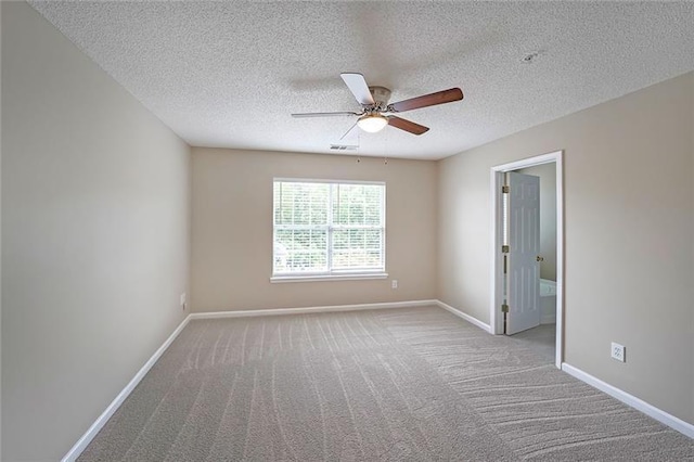 carpeted empty room with a textured ceiling and ceiling fan