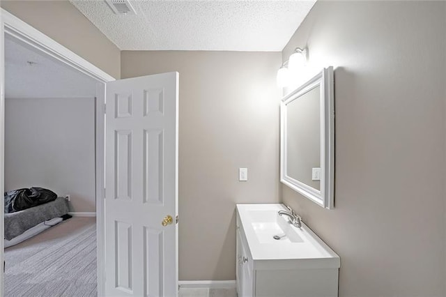 bathroom with a textured ceiling and vanity