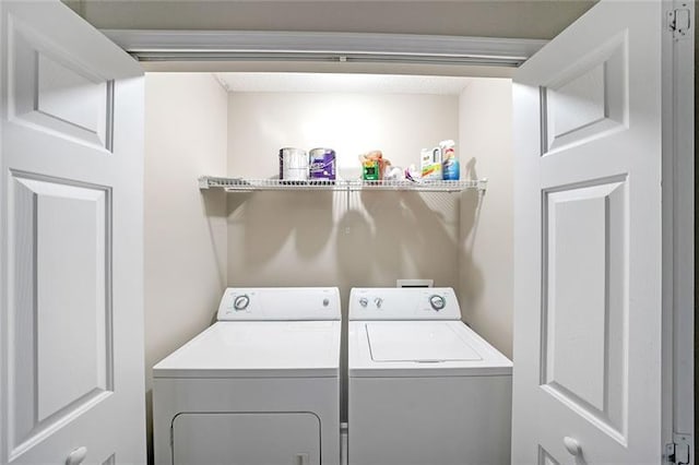 washroom with washer and dryer