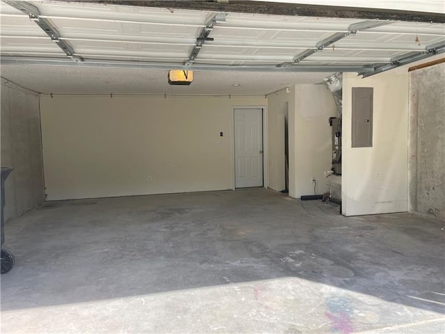 garage with a garage door opener and electric panel