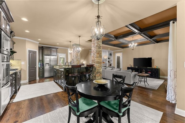 dining space featuring an inviting chandelier, ornamental molding, baseboards, ornate columns, and dark wood-style floors