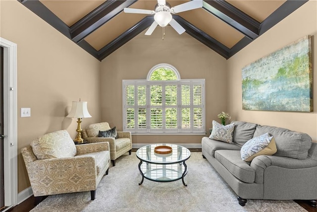 living area featuring baseboards, a ceiling fan, beam ceiling, and high vaulted ceiling