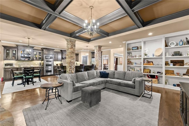 living room with crown molding, dark wood-style flooring, beam ceiling, ornate columns, and coffered ceiling