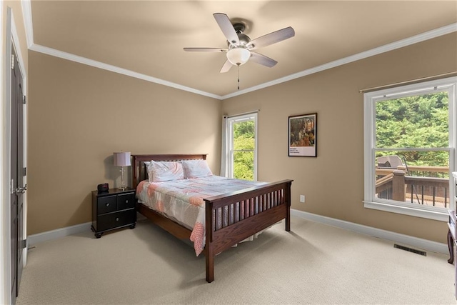 bedroom featuring baseboards, ornamental molding, light carpet, and ceiling fan
